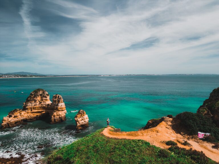 Arial view of Lagos' stunning coast with rock formations, clear sea, and lush landscape.