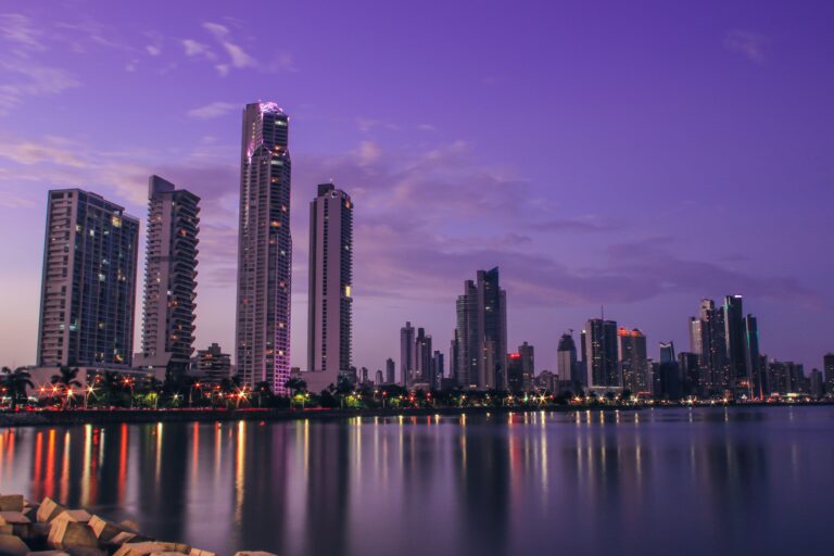 Stunning Panama City skyline reflecting on water at twilight, showcasing modern architecture.