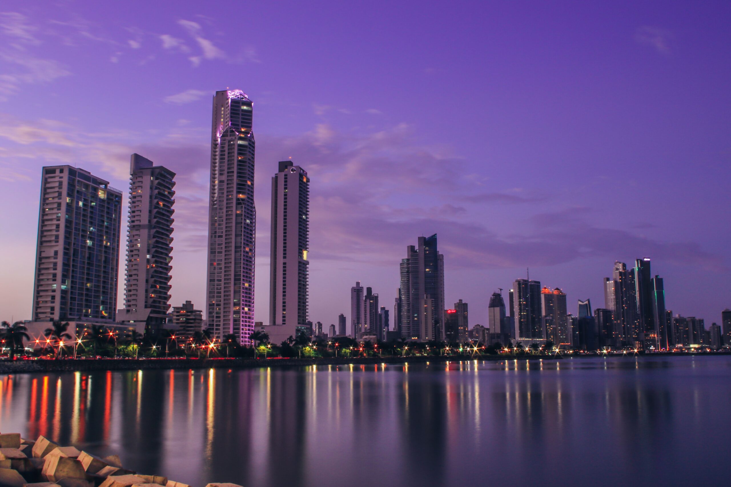Stunning Panama City skyline reflecting on water at twilight, showcasing modern architecture.
