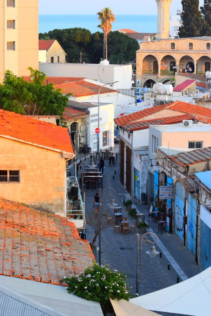 Aerial view of a vibrant alley in Larnaca, Cyprus, with colorful rooftops and Mediterranean architecture.