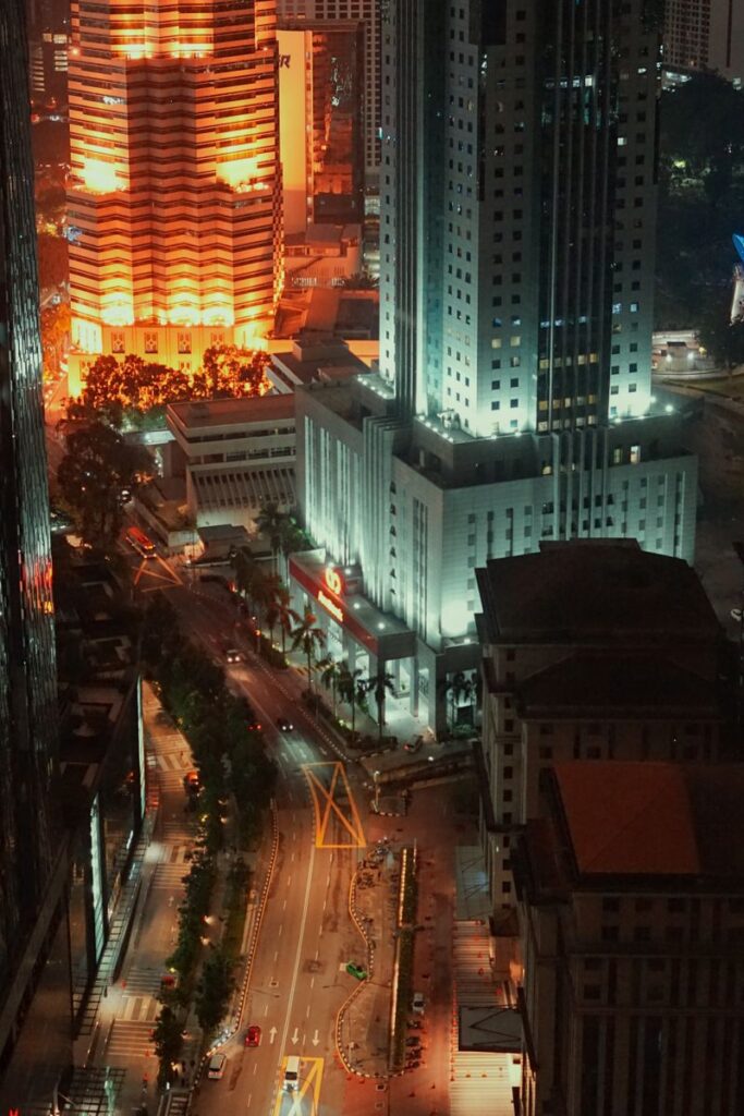 Stunning aerial view of Kuala Lumpur's illuminated skyline, showcasing vibrant nightlife.