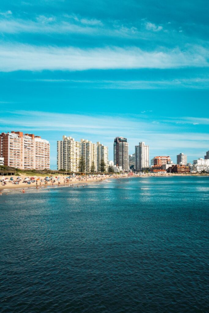 Explore the stunning skyline and beach of Punta del Este, Uruguay, on a sunny day with clear blue skies and vibrant cityscape.